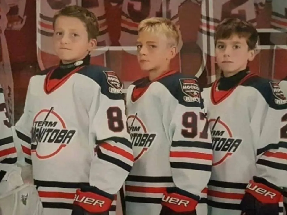 3 young hockey players in Team Manitoba jerseys